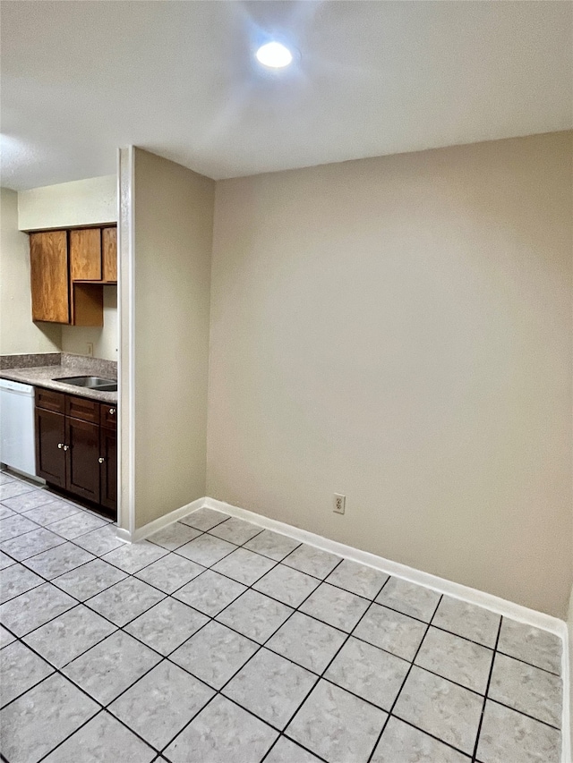 kitchen featuring sink, dishwasher, and light tile floors