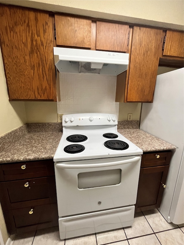 kitchen featuring backsplash, white appliances, and light tile patterned floors