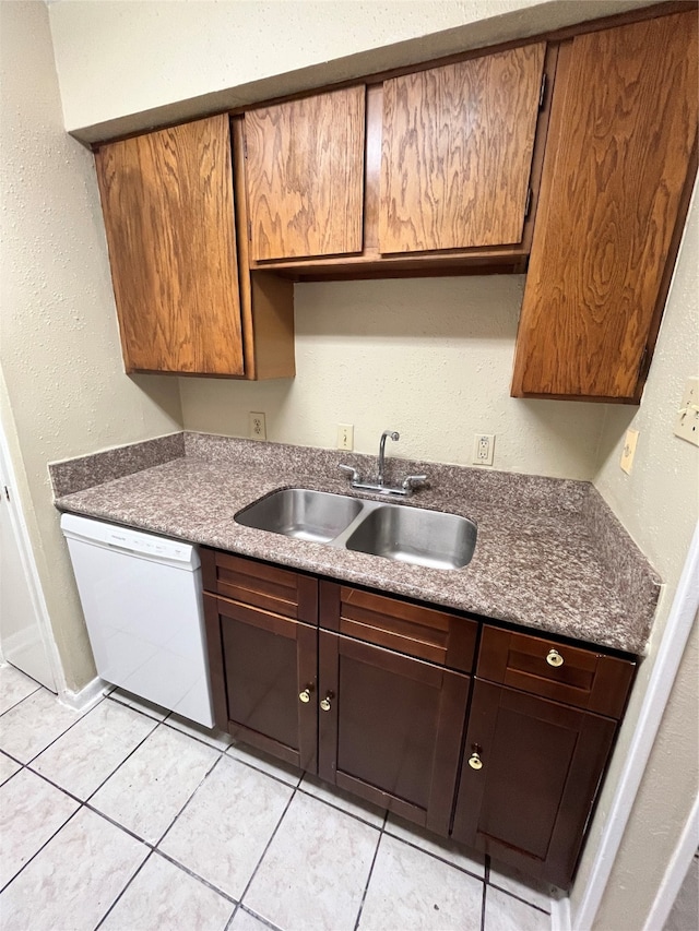 kitchen with dishwasher, sink, and light tile patterned flooring