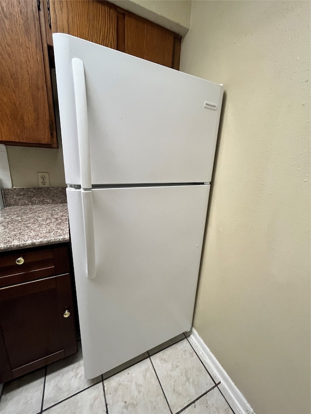 kitchen featuring white fridge and light tile patterned floors