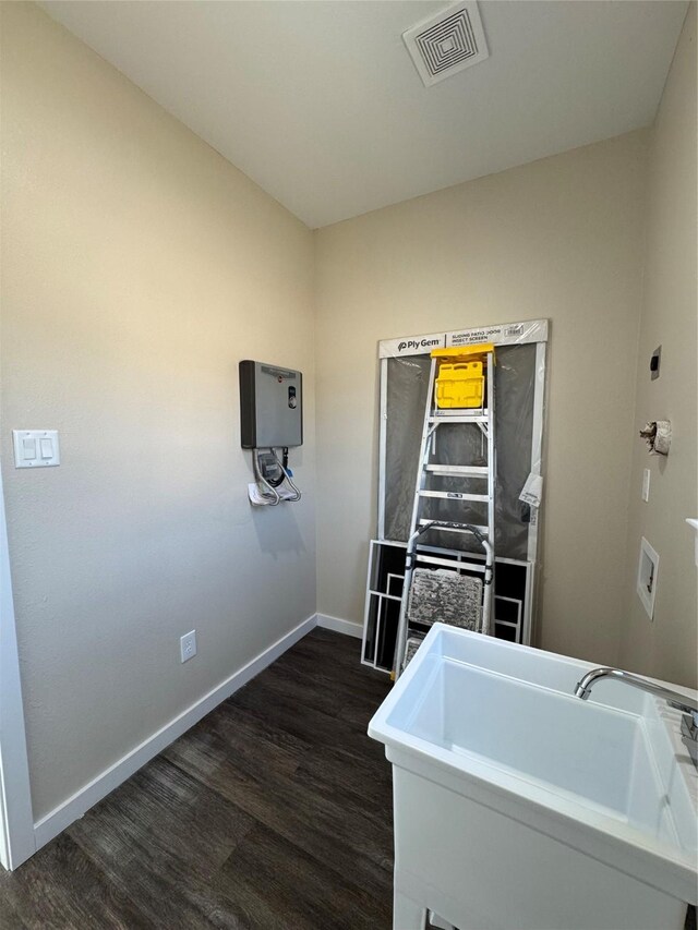 washroom with dark hardwood / wood-style floors and sink