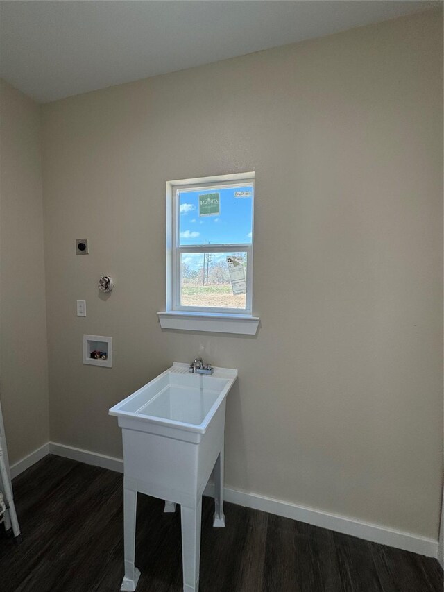 clothes washing area with electric dryer hookup, hookup for a washing machine, and dark hardwood / wood-style floors