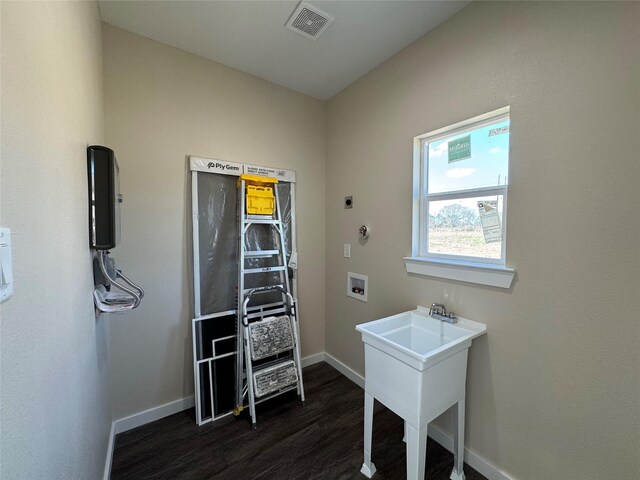 laundry area with sink, dark hardwood / wood-style flooring, hookup for a washing machine, and electric dryer hookup