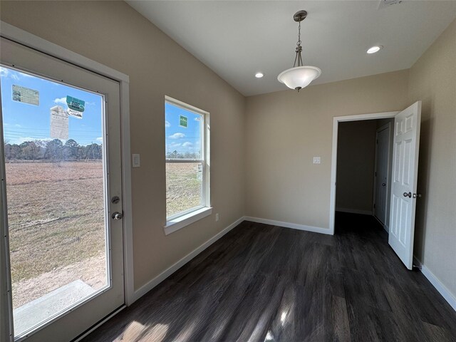 unfurnished dining area with dark hardwood / wood-style floors