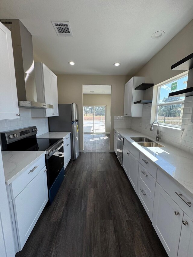 kitchen with sink, white cabinetry, stainless steel appliances, dark hardwood / wood-style flooring, and wall chimney exhaust hood