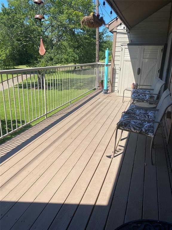 wooden terrace with a yard