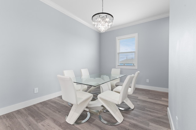 dining room featuring a notable chandelier, crown molding, and wood-type flooring