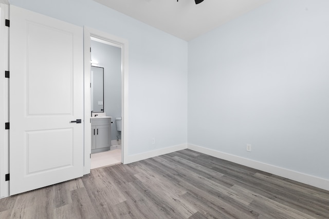 empty room featuring ceiling fan and hardwood / wood-style floors