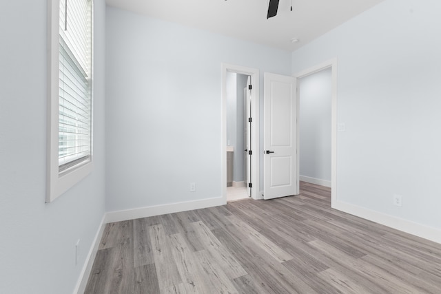 spare room featuring ceiling fan and light hardwood / wood-style floors