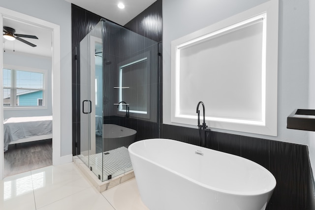 bathroom featuring tile flooring, ceiling fan, and plus walk in shower