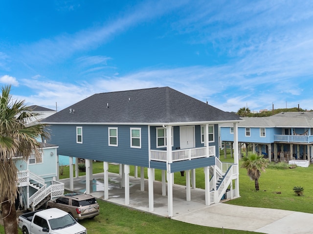 rear view of house with a yard and a carport