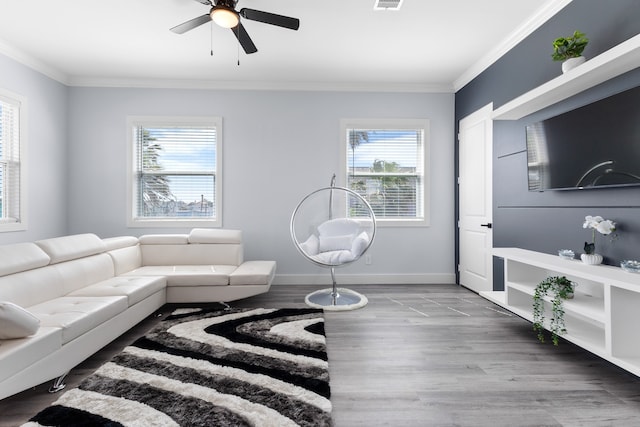 living room featuring light hardwood / wood-style flooring, ceiling fan, and crown molding