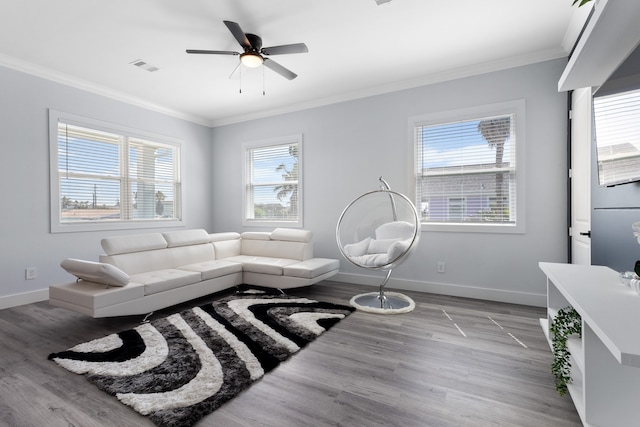 living room with crown molding, light hardwood / wood-style floors, and ceiling fan