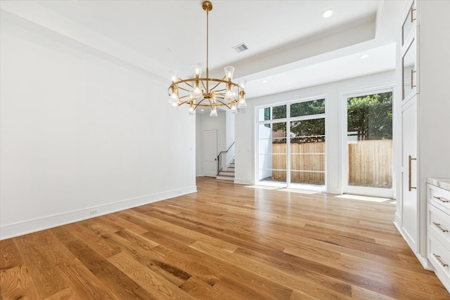 interior space featuring a notable chandelier and light hardwood / wood-style flooring