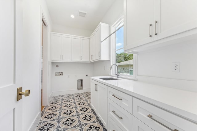 washroom featuring light tile patterned floors, cabinets, sink, and hookup for an electric dryer