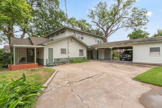 back of house featuring a carport