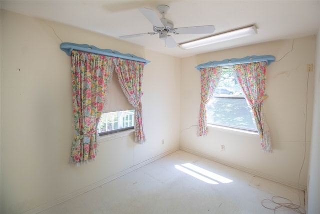 empty room with concrete flooring and ceiling fan