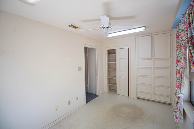 unfurnished bedroom with ceiling fan and a closet