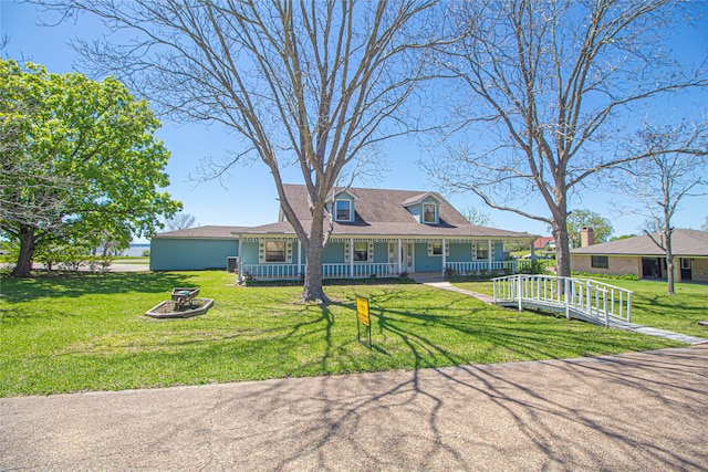 view of front of property with a fire pit, a front lawn, and a porch