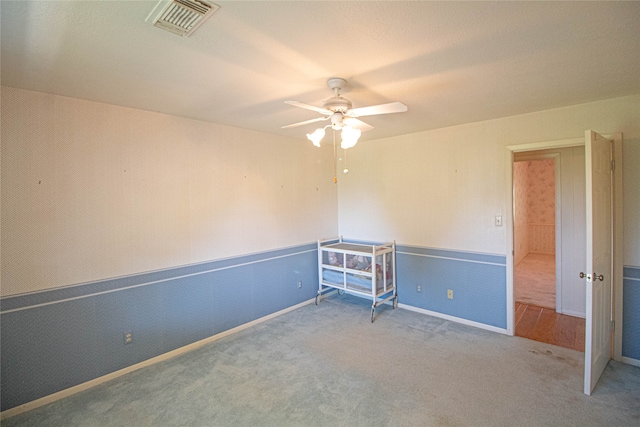 unfurnished room featuring ceiling fan and light colored carpet