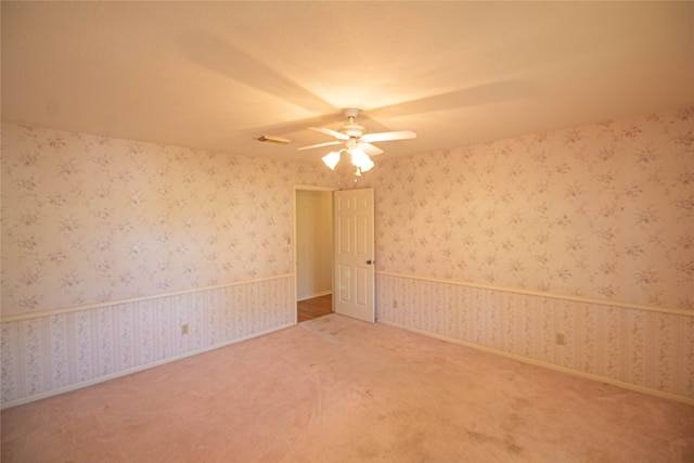 carpeted empty room featuring ceiling fan