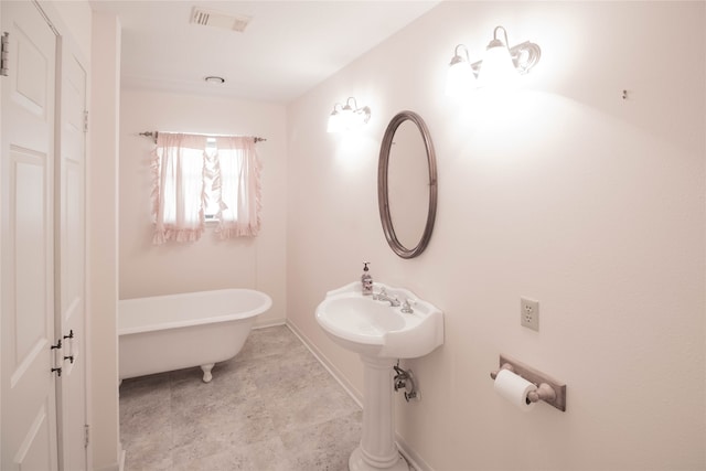 bathroom featuring tile floors and a washtub