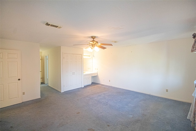 carpeted empty room featuring ceiling fan