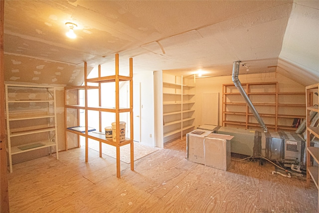 interior space featuring hardwood / wood-style flooring and vaulted ceiling