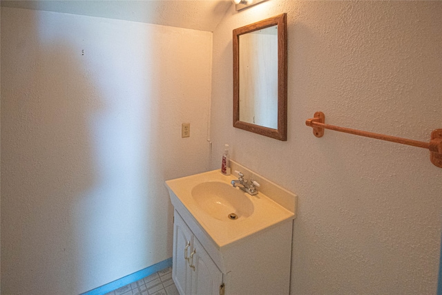 bathroom featuring tile flooring and vanity with extensive cabinet space