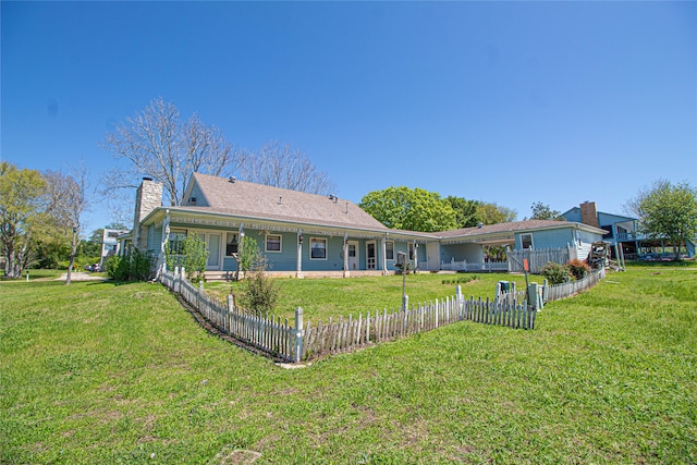 back of house with a lawn