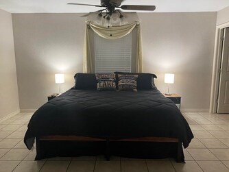 tiled bedroom with ceiling fan