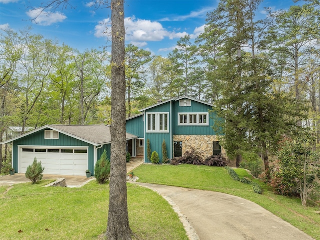 view of front of property with a garage and a front lawn