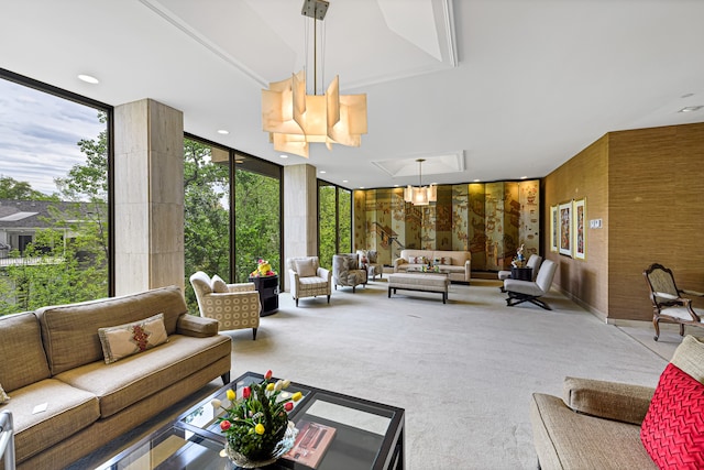 living room with floor to ceiling windows and light colored carpet