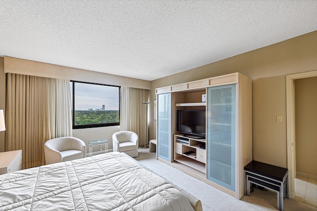 carpeted bedroom featuring a textured ceiling