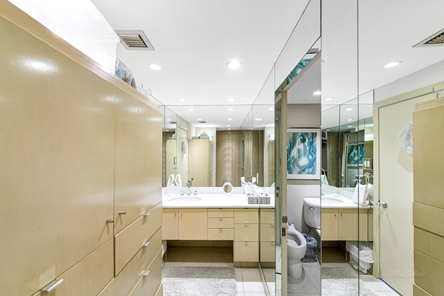 bathroom featuring a bidet, tile flooring, vanity, and toilet