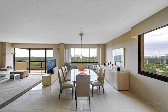 dining space with a textured ceiling and light tile flooring