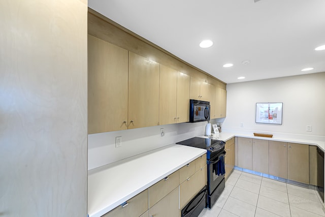 kitchen with light tile floors and black appliances