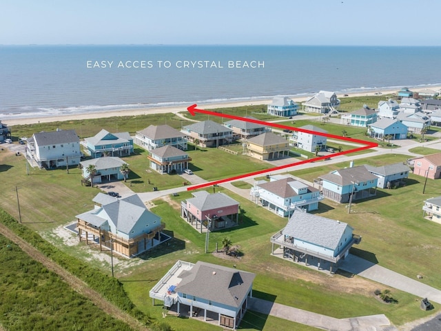 drone / aerial view featuring a view of the beach and a water view