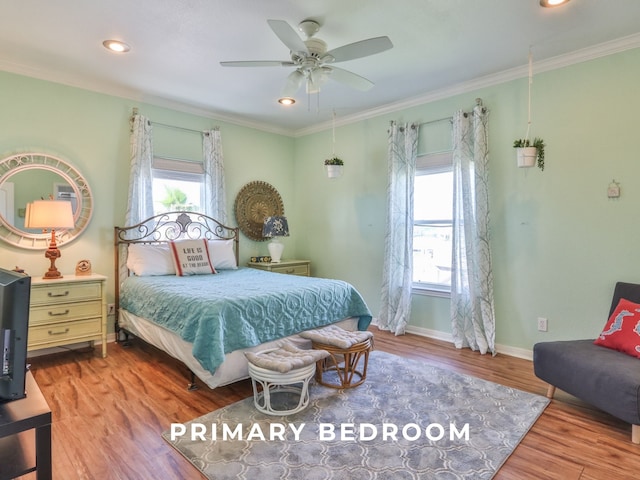 bedroom featuring light hardwood / wood-style floors, ceiling fan, and ornamental molding