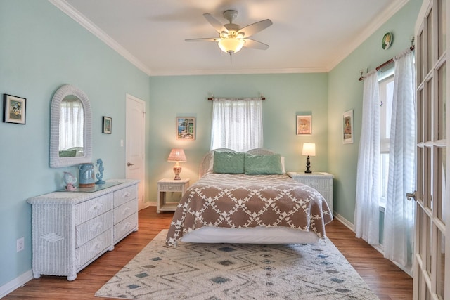 bedroom with crown molding, ceiling fan, and light hardwood / wood-style flooring