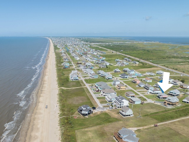 aerial view with a water view and a beach view