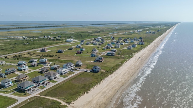 drone / aerial view with a beach view and a water view