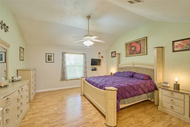 bedroom with lofted ceiling, light wood-style flooring, baseboards, and ceiling fan