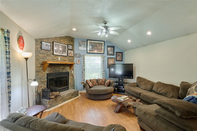 living room featuring ceiling fan, a fireplace, hardwood / wood-style flooring, and lofted ceiling