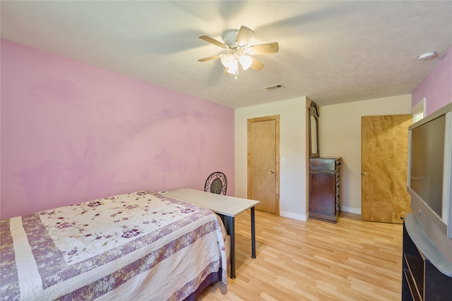 bedroom featuring light wood-type flooring and ceiling fan