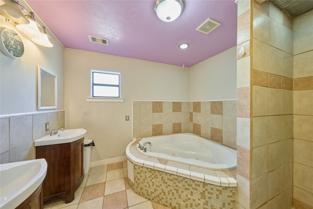 bathroom featuring tile walls, tile patterned floors, and vanity