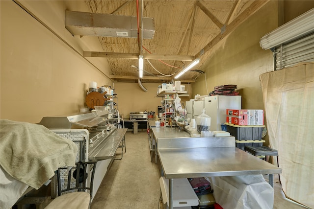 kitchen with freestanding refrigerator and stainless steel countertops