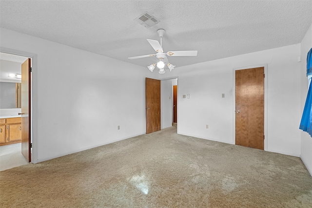 spare room with light carpet, a textured ceiling, and ceiling fan