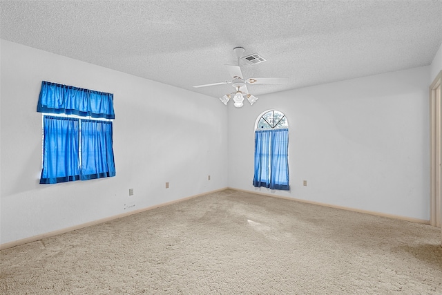 unfurnished room with light carpet, a textured ceiling, and ceiling fan