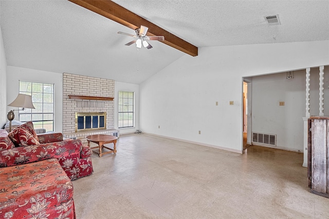 tiled living room with ceiling fan, a fireplace, brick wall, a textured ceiling, and lofted ceiling with beams